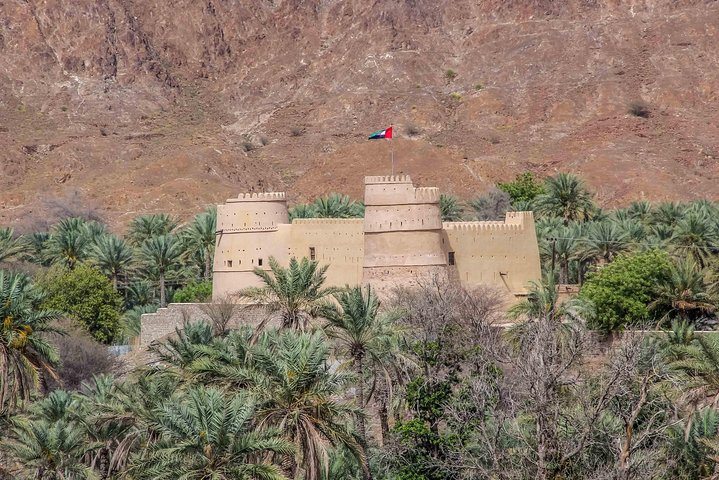 Explore the rich history of Fujairah Fort nestled among lush palm trees and rugged mountains offering a glimpse into the region's past and a perfect backdrop for your East Coast adventure.